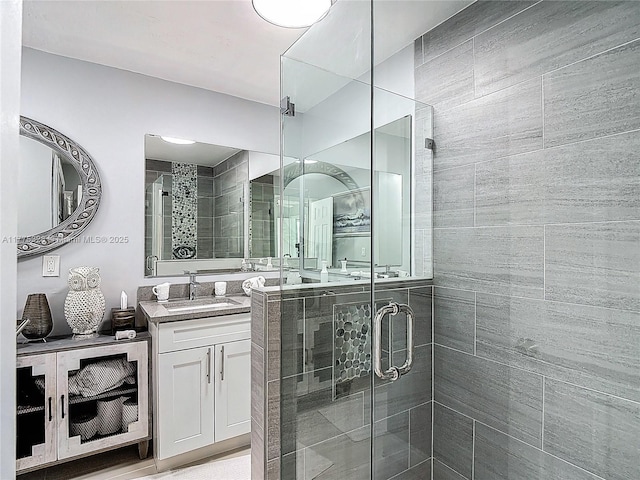 bathroom featuring vanity and a stall shower