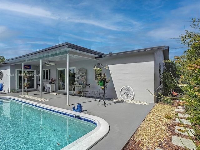 back of house with a patio, ceiling fan, an outdoor pool, and stucco siding