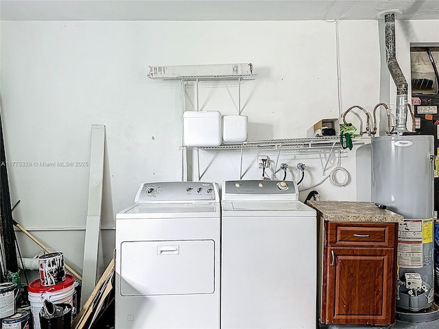 washroom with cabinet space, separate washer and dryer, and gas water heater