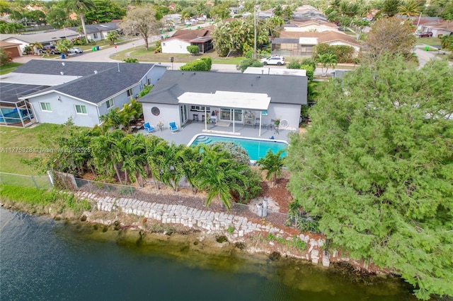 drone / aerial view featuring a water view and a residential view