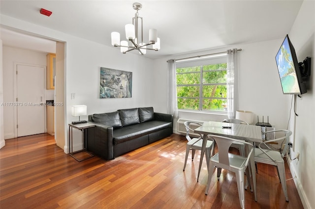 living area with a chandelier and wood finished floors