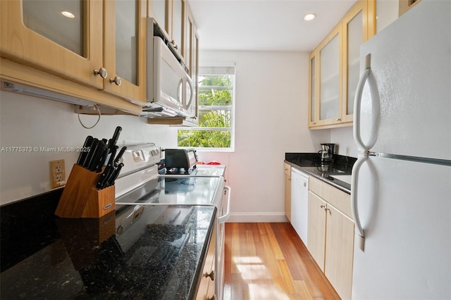 kitchen with light wood-type flooring, baseboards, white appliances, and glass insert cabinets