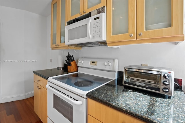 kitchen featuring dark wood-style flooring, baseboards, a toaster, white appliances, and glass insert cabinets