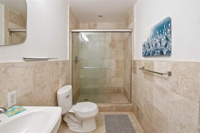 full bath featuring toilet, tile walls, and a shower stall