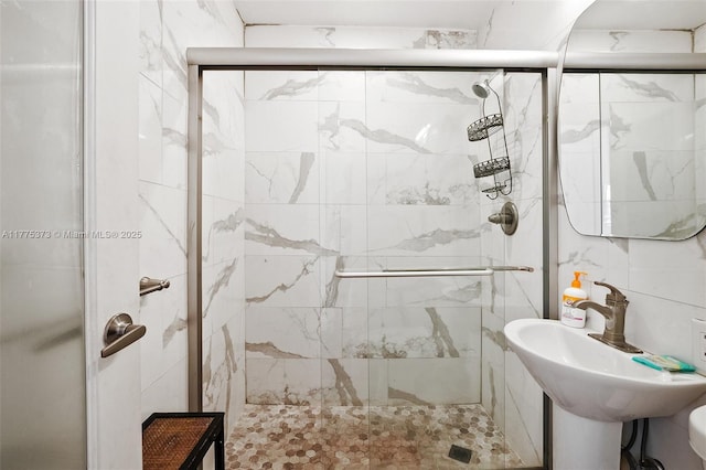 full bathroom featuring a sink and a shower stall