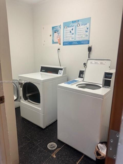 community laundry room featuring washer and clothes dryer