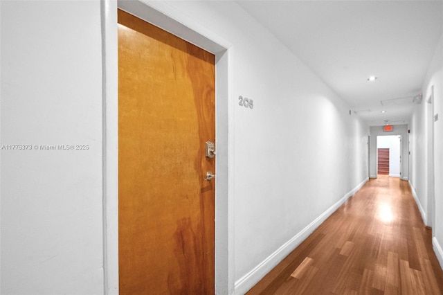 hall featuring wood finished floors and baseboards