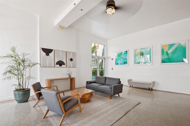 living area featuring baseboards and ceiling fan