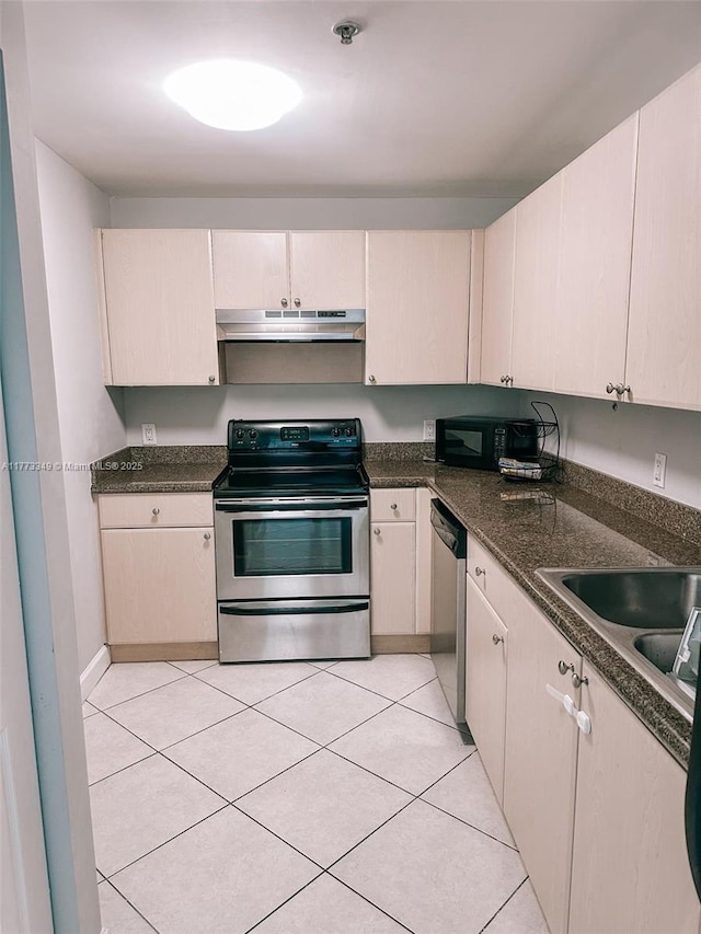 2280 SW 32nd Ave Unit 510, Miami, FL 33145 - kitchen with dark countertops, light tile patterned flooring, stainless steel appliances, and under cabinet range hood