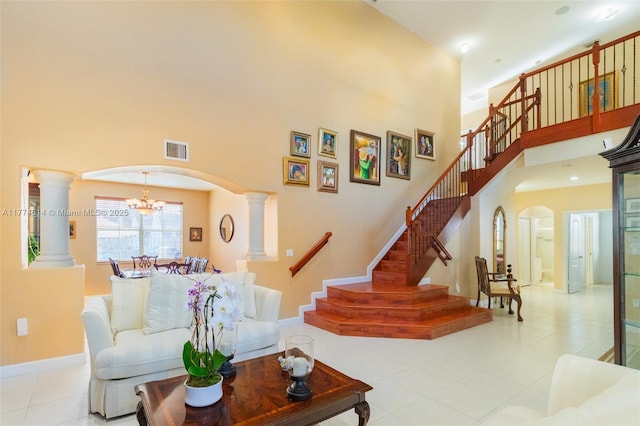 1411 SW 149th Pl, Miami, FL 33194 - living area with arched walkways, a towering ceiling, decorative columns, and stairway