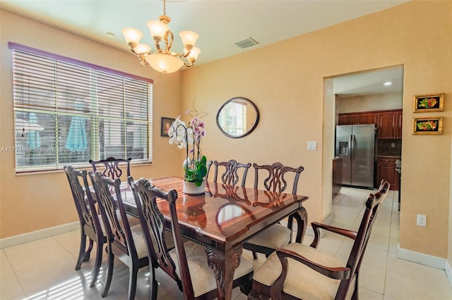 dining area featuring visible vents, baseboards, light tile patterned floors, and a chandelier