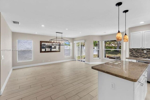 10766 Crescendo Cir, Boca Raton, FL 33498 - kitchen with dishwasher, baseboards, light wood finished floors, a center island, and recessed lighting