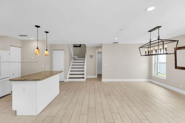 10766 Crescendo Cir, Boca Raton, FL 33498 - kitchen featuring baseboards, recessed lighting, light wood-style flooring, freestanding refrigerator, and pendant lighting