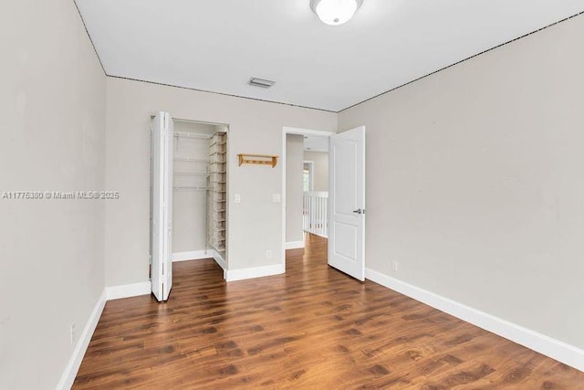 10766 Crescendo Cir, Boca Raton, FL 33498 - unfurnished bedroom featuring wood finished floors, a closet, and baseboards