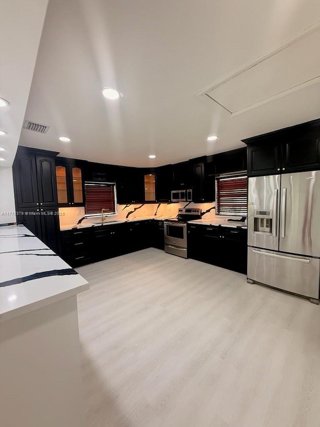 4529 SW 24th St, Fort Lauderdale, FL 33317 - kitchen with recessed lighting, light countertops, visible vents, dark cabinetry, and appliances with stainless steel finishes