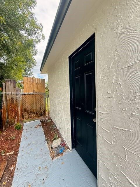 4529 SW 24th St, Fort Lauderdale, FL 33317 - entrance to property featuring stucco siding and fence