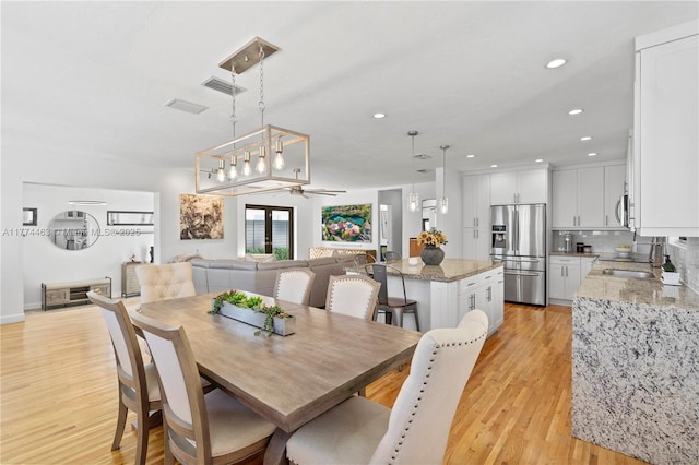 dining area featuring light wood-type flooring, ceiling fan, visible vents, and recessed lighting