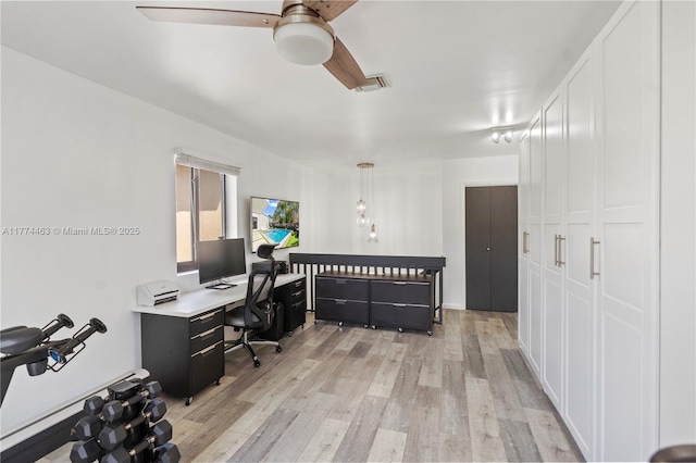 office area with light wood-style flooring, a ceiling fan, and visible vents