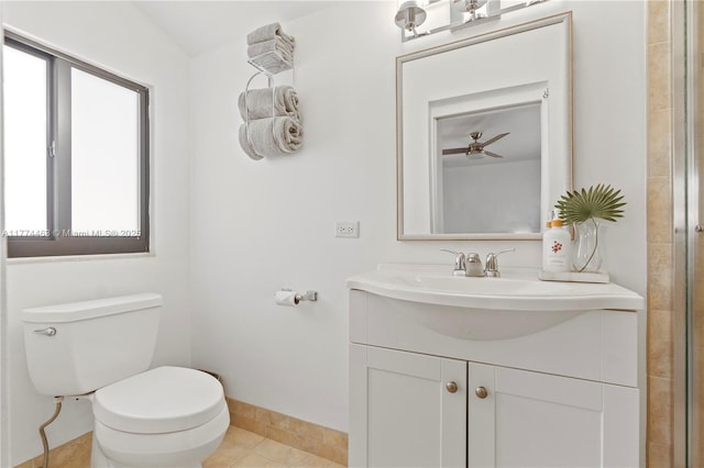 bathroom with toilet, vanity, baseboards, and tile patterned flooring