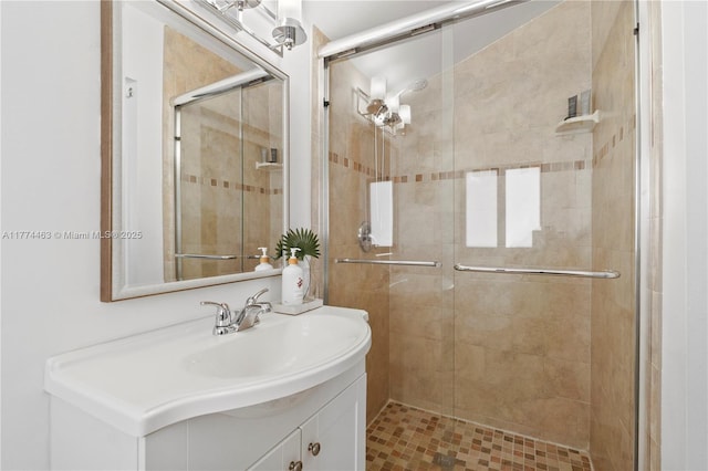bathroom with a stall shower and vanity
