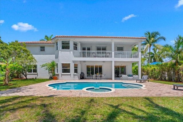 1427 Victoria Isle Dr, Weston, FL 33327 - rear view of property featuring a balcony, a patio, a lawn, and stucco siding