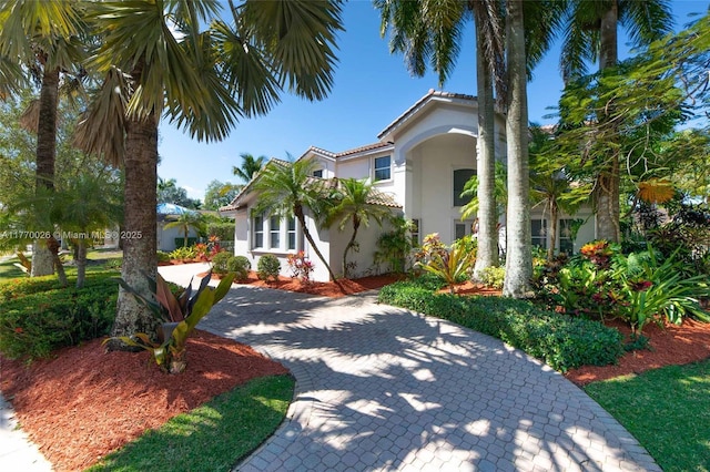 view of front of property with stucco siding and a tile roof
