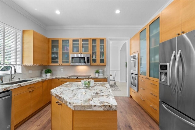 1427 Victoria Isle Dr, Weston, FL 33327 - kitchen featuring stainless steel appliances, a sink, wood finished floors, a center island, and crown molding