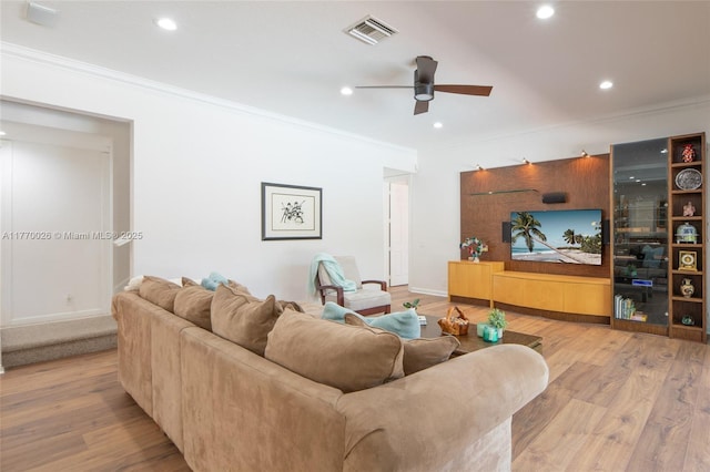 living area with recessed lighting, visible vents, ornamental molding, and wood finished floors