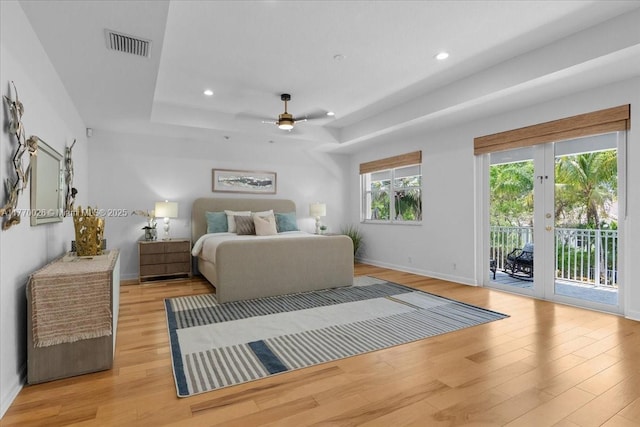 1427 Victoria Isle Dr, Weston, FL 33327 - bedroom with access to exterior, a tray ceiling, light wood finished floors, baseboards, and recessed lighting