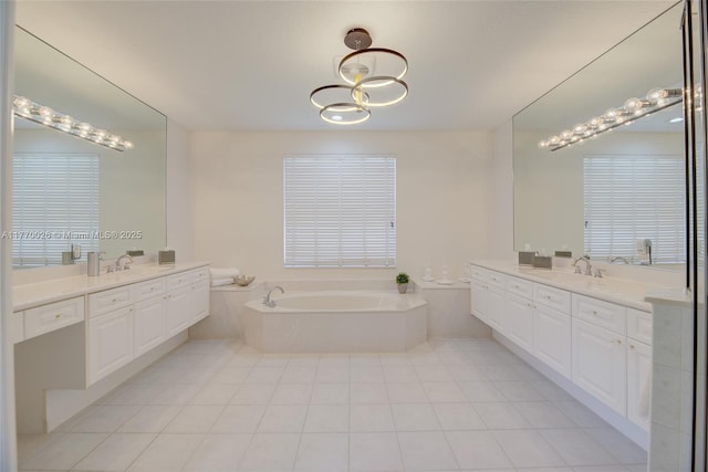full bathroom featuring tile patterned floors, two vanities, a sink, and a garden tub