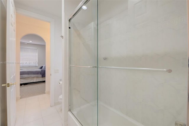 full bathroom featuring toilet, tile patterned floors, and ensuite bath