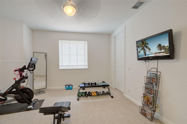 exercise room with baseboards, carpet, and visible vents