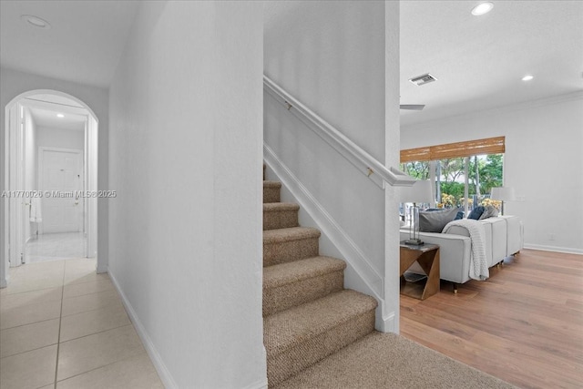 1427 Victoria Isle Dr, Weston, FL 33327 - staircase featuring arched walkways, recessed lighting, baseboards, and wood finished floors