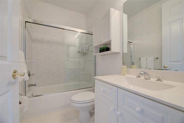 bathroom featuring tile patterned flooring, vanity, shower / bath combination with glass door, and toilet