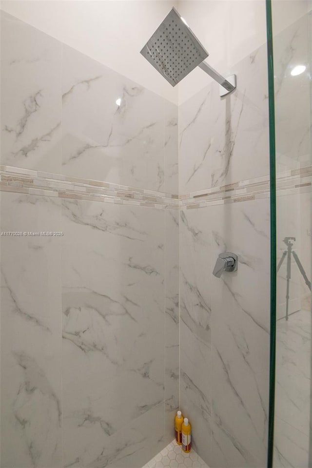 bathroom with a marble finish shower