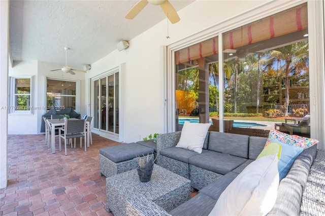 view of patio / terrace featuring a fenced in pool, outdoor dining area, ceiling fan, and an outdoor hangout area