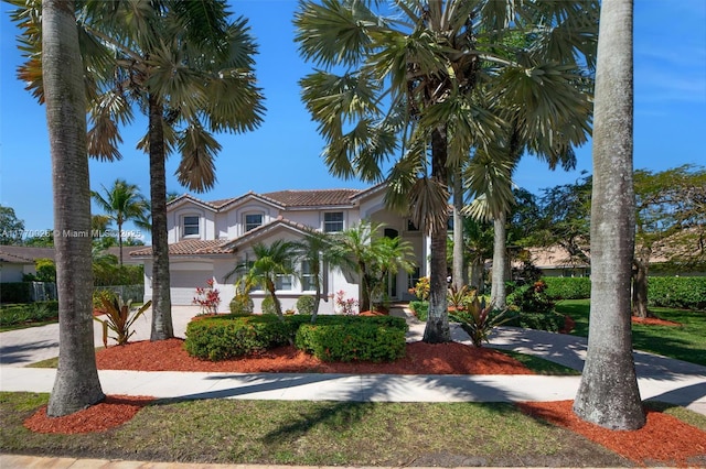 mediterranean / spanish-style house featuring stucco siding and a tile roof