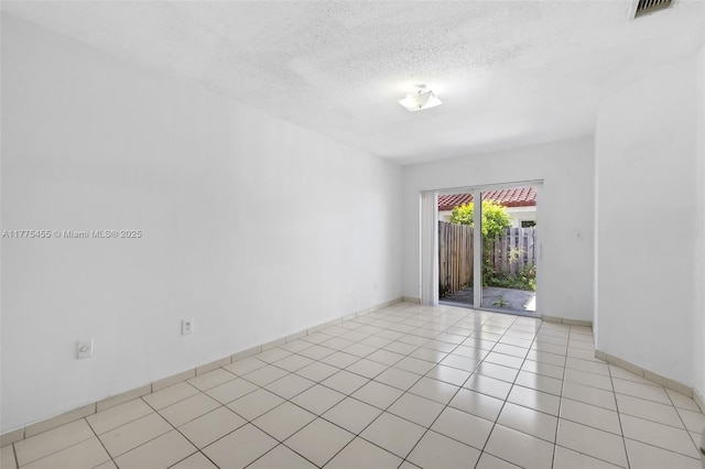 20747 SW 81st Pl Unit 20747, Cutler Bay, FL 33189 - unfurnished room with baseboards, visible vents, light tile patterned floors, and a textured ceiling