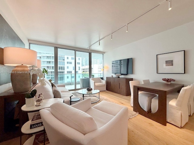 1331 Brickell Bay Dr Unit 506, Miami, FL 33131 - living area with rail lighting, light wood-style floors, and floor to ceiling windows