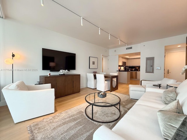 1331 Brickell Bay Dr Unit 506, Miami, FL 33131 - living room with electric panel, light wood-style flooring, and rail lighting