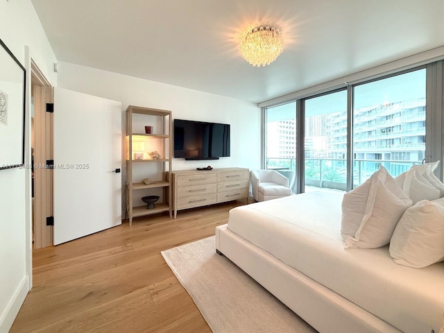 1331 Brickell Bay Dr Unit 506, Miami, FL 33131 - bedroom with light wood-style flooring and a chandelier