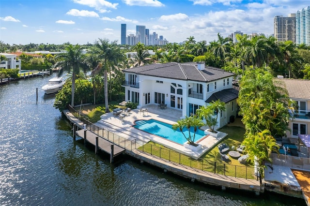 455 Centre Is, Golden Beach, FL 33160 - rear view of house featuring fence, a fenced in pool, a water view, a balcony, and a patio