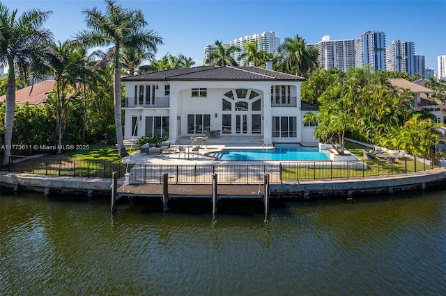 455 Centre Is, Golden Beach, FL 33160 - back of property with a balcony, a patio, a fenced backyard, a fenced in pool, and a water view