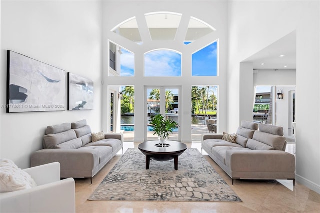 455 Centre Is, Golden Beach, FL 33160 - living area featuring a water view, light tile patterned floors, and a towering ceiling