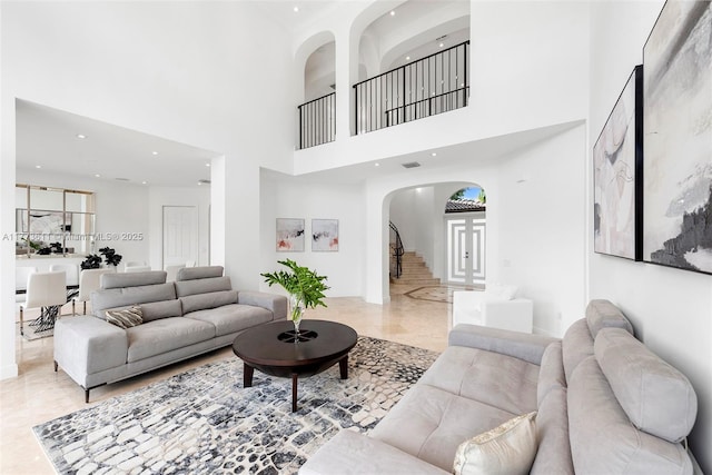 455 Centre Is, Golden Beach, FL 33160 - living area with arched walkways, stairway, marble finish floor, a high ceiling, and recessed lighting