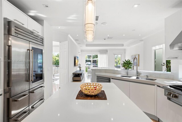 455 Centre Is, Golden Beach, FL 33160 - kitchen with light countertops, white cabinetry, appliances with stainless steel finishes, and a sink
