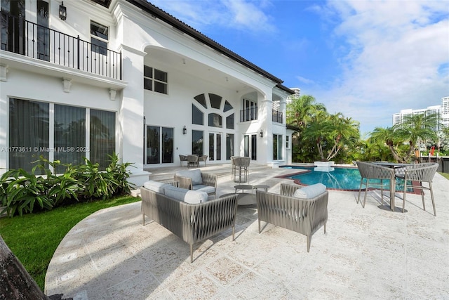 455 Centre Is, Golden Beach, FL 33160 - view of patio featuring a pool with connected hot tub, a balcony, and an outdoor hangout area