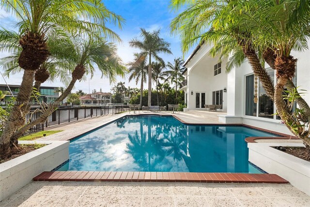 455 Centre Is, Golden Beach, FL 33160 - view of swimming pool featuring a fenced in pool, fence, and a patio