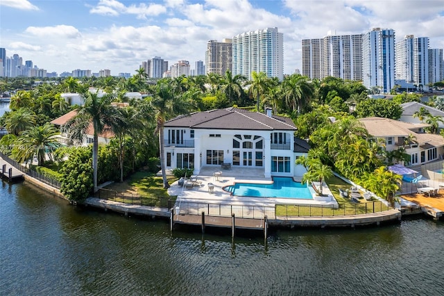 455 Centre Is, Golden Beach, FL 33160 - back of property with a balcony, a fenced backyard, an outdoor pool, a view of city, and a patio area