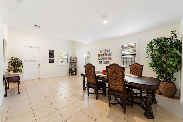 dining space with light tile patterned flooring and visible vents
